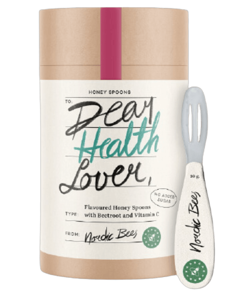 Tube of flavoured honey spoons with beetroot beside a Nordic Bees honey spoon