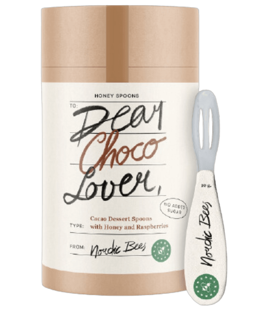 Tube of Dear Choco Lover cacao dessert spoons with honey and raspberries beside a Nordic Bees honey spoon